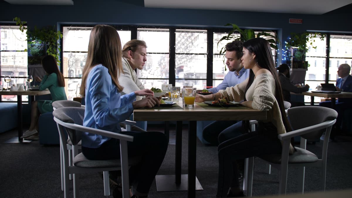 Group of positive young students communicating at a meeting