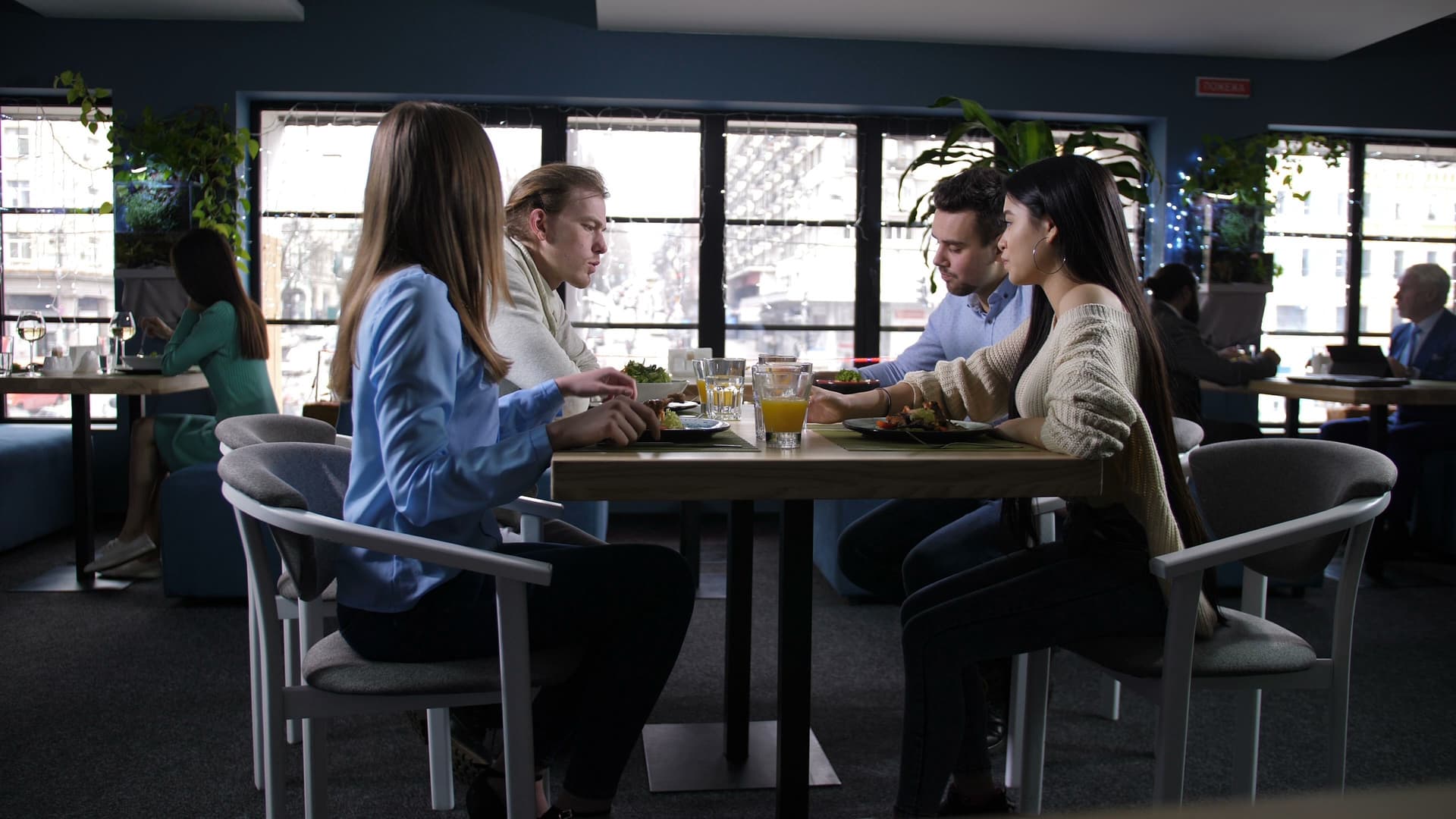 Group of positive young students communicating at a meeting