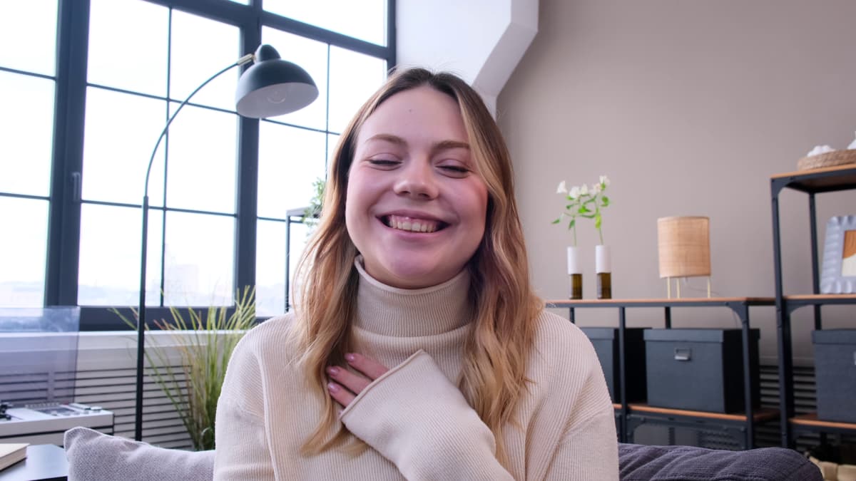 Woman laughing during an online video call at home