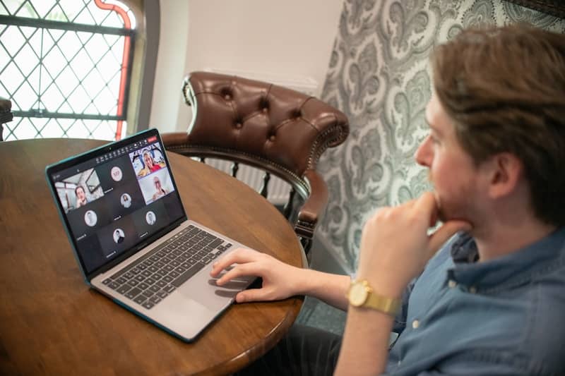 Man at a round table with a laptop