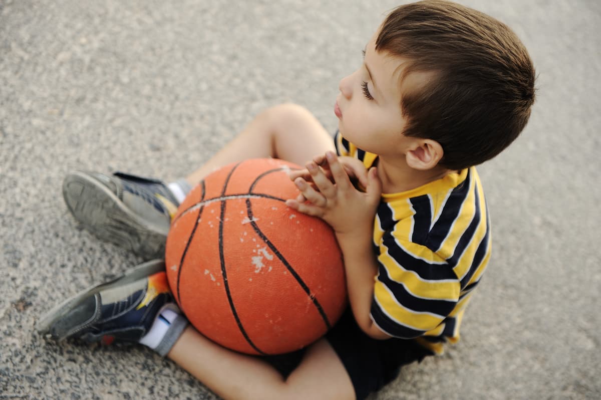 Kid practicing with a basketball